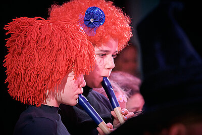 2 Kinder spielen Blockflöte - verkleidet als Clowns
