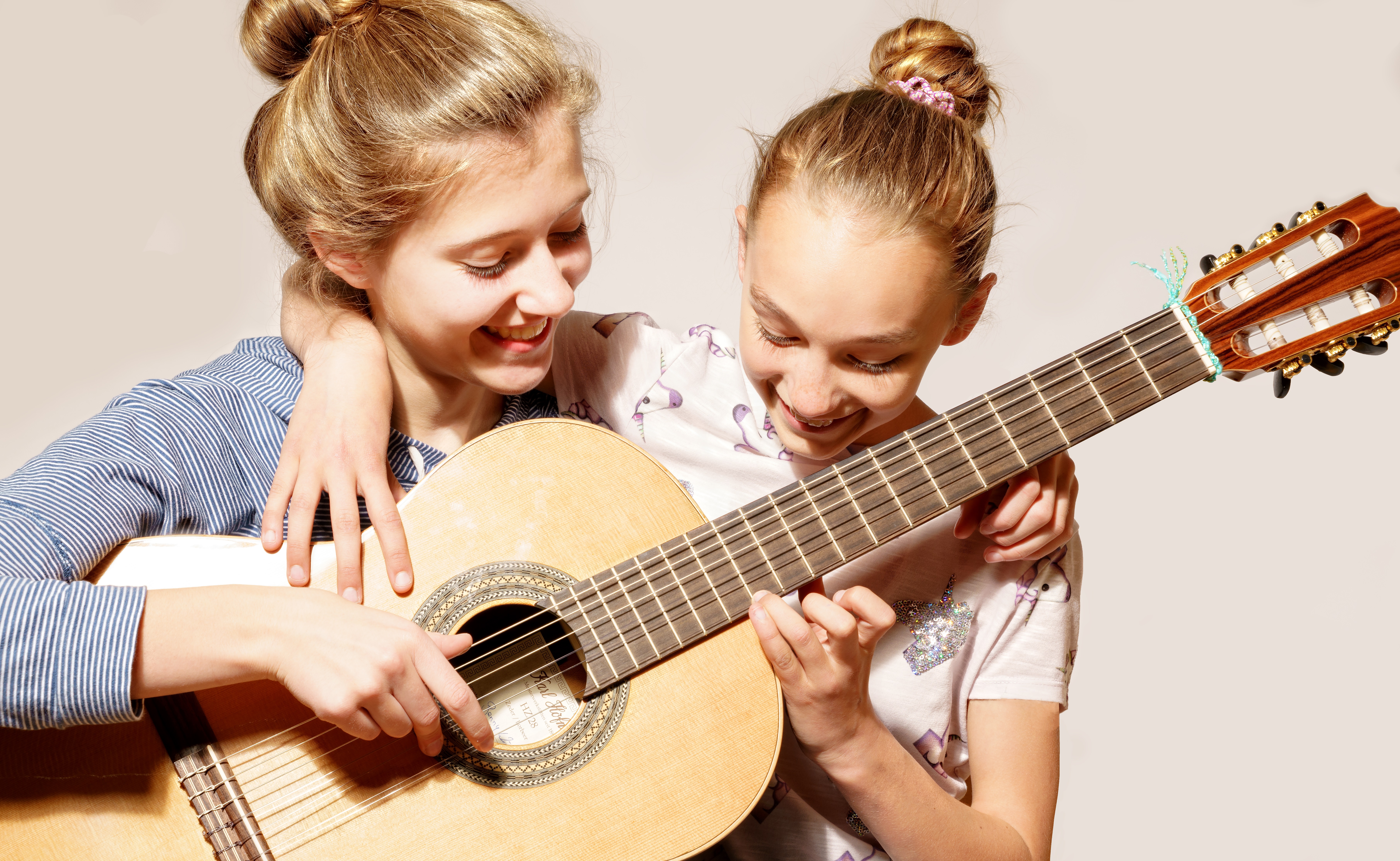 Zwei Gitarre spielende Personen.